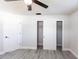 Bedroom features gray plank flooring, ceiling fan, closet with shelving and a window at 11176 3Rd Ave, Punta Gorda, FL 33955