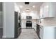 Modern kitchen featuring all-white cabinetry, stainless steel appliances, and sleek quartz countertops at 11176 3Rd Ave, Punta Gorda, FL 33955