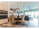 Inviting dining area featuring stylish decor, modern lighting, and seamless transition to the living room at 11723 1St E St, Treasure Island, FL 33706