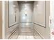 Interior shot of an elevator with gray panels, metal handrails, and flooring at 11723 1St E St, Treasure Island, FL 33706