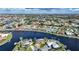 Aerial view of waterfront homes showcasing beautiful canal access and lush landscaping at 1200 Winward Ct, Punta Gorda, FL 33950