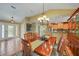 Elegant dining room with a chandelier, adjacent to the kitchen and living areas at 1200 Winward Ct, Punta Gorda, FL 33950