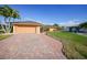 Beautiful single-story home with a brick driveway, lush lawn, and well-maintained landscaping at 1200 Winward Ct, Punta Gorda, FL 33950