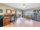 Bright home office with desk, sliding glass doors, natural light, and built-in shelving at 1200 Winward Ct, Punta Gorda, FL 33950