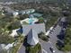 Aerial view of community clubhouse with a pool, tennis court, and parking at 1286 Green Oak Trl, Port Charlotte, FL 33948