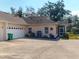 Single-story home with a two-car garage, manicured landscaping, and a welcoming front entrance at 1286 Green Oak Trl, Port Charlotte, FL 33948