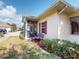 A charming home featuring a screened lanai with a bench in front of a window at 1286 Green Oak Trl, Port Charlotte, FL 33948