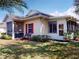 Charming home featuring a screened lanai, manicured lawn, and inviting bench, perfect for outdoor relaxation at 1286 Green Oak Trl, Port Charlotte, FL 33948