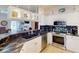 Bright kitchen with stainless steel appliances, white cabinets, and black countertops at 1286 Green Oak Trl, Port Charlotte, FL 33948