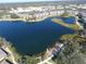 Aerial view of a community pond and walking trail surrounded by lush landscaping and buildings at 1286 Green Oak Trl, Port Charlotte, FL 33948