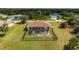 Overhead shot showcases the home's screened-in pool, fenced backyard, and lush surroundings at 13157 Ridgely Cir, Port Charlotte, FL 33981