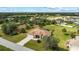 Aerial view of a well-maintained home with a screened-in pool, mature landscaping, and a paved driveway at 13157 Ridgely Cir, Port Charlotte, FL 33981