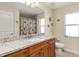 Bathroom boasts granite counters, tile flooring, and natural light from a large window at 13157 Ridgely Cir, Port Charlotte, FL 33981