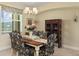 Traditional dining room featuring a chandelier, large window, and decorative floral accents at 13157 Ridgely Cir, Port Charlotte, FL 33981