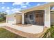 Inviting front porch with seating area, screen enclosure, and an attached two car garage at 13157 Ridgely Cir, Port Charlotte, FL 33981