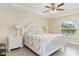 Comfortable bedroom with a ceiling fan, natural light, and stylish decor at 13157 Ridgely Cir, Port Charlotte, FL 33981