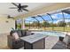 Enclosed patio with outdoor seating near the pool offers ultimate relaxation and entertainment at 13157 Ridgely Cir, Port Charlotte, FL 33981