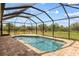 Screened pool with brick pavers, a safety fence and a tranquil backyard view at 13157 Ridgely Cir, Port Charlotte, FL 33981