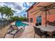 Inviting backyard pool area with outdoor seating and lush tropical landscaping, perfect for relaxation at 1344 Mediterranean Dr # 121, Punta Gorda, FL 33950