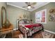 Charming bedroom with unique decor, wood floors, natural lighting, and ceiling fan at 1344 Mediterranean Dr # 121, Punta Gorda, FL 33950