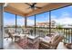 Relaxing screened patio area with comfortable seating, ceiling fan, and beautiful waterfront views at 1344 Mediterranean Dr # 121, Punta Gorda, FL 33950