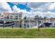 Beautiful waterfront view with boat dock and lift, adjacent to a stunning yellow condo building at 1344 Mediterranean Dr # 121, Punta Gorda, FL 33950