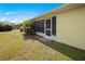 Yellow House has green grass, screened-in porch at 1364 Ultramarine Ln, Punta Gorda, FL 33983