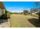 Green grass lawn, hose, various shrubs and trees at 1364 Ultramarine Ln, Punta Gorda, FL 33983