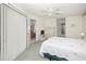 Neutral bedroom featuring carpet, ceiling fan, and an attached bathroom at 1364 Ultramarine Ln, Punta Gorda, FL 33983