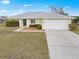 Well-maintained single-Gathering home featuring mature landscaping and a two-car garage at 1364 Ultramarine Ln, Punta Gorda, FL 33983