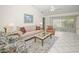 Comfortable living room featuring tile floors, bright lighting, and a sliding glass door to the lanai at 1364 Ultramarine Ln, Punta Gorda, FL 33983