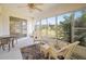 Bright sunroom with wicker furniture, view of the backyard, and ceiling fan at 1364 Ultramarine Ln, Punta Gorda, FL 33983