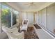 Enclosed sunroom with white wicker furniture and sliding glass doors at 1364 Ultramarine Ln, Punta Gorda, FL 33983