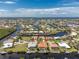 Wide aerial shot of a canal community, showcasing the waterfront property and beautiful landscaping at 1453 Wren Ct, Punta Gorda, FL 33950