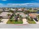 Aerial view of home with tile roof, lush landscaping, and a circular driveway at 1453 Wren Ct, Punta Gorda, FL 33950