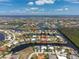 An aerial view shows a waterfront community with access to deep water and luxurious homes at 1453 Wren Ct, Punta Gorda, FL 33950