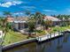 Aerial view of the canal-front home with screened-in porch and private dock at 1453 Wren Ct, Punta Gorda, FL 33950