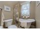 Bathroom with a standalone soaking tub, decorative shower screen, and elegant finishes at 1453 Wren Ct, Punta Gorda, FL 33950