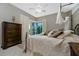 Well-lit bedroom featuring a decorative bed, a ceiling fan, and a sliding door to a lanai at 1453 Wren Ct, Punta Gorda, FL 33950