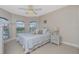 Comfortable bedroom featuring a decorative ceiling fan, large windows, and neutral tones at 1453 Wren Ct, Punta Gorda, FL 33950