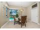 Breakfast nook with glass table and pool view through sliding glass doors at 1453 Wren Ct, Punta Gorda, FL 33950