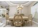 Formal dining room featuring an elegant chandelier, decorative mirror, and seating for six at 1453 Wren Ct, Punta Gorda, FL 33950