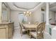 Elegant dining room featuring chandelier, decorative tray ceiling, and seating for four, ideal for Gathering meals at 1453 Wren Ct, Punta Gorda, FL 33950