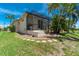 Exterior view of the house shows a screened-in porch, blending indoor and outdoor living spaces with backyard landscaping at 1453 Wren Ct, Punta Gorda, FL 33950