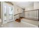 Inviting foyer with tile flooring, decorative glass door, and wooden staircase, creating a warm entrance at 1453 Wren Ct, Punta Gorda, FL 33950