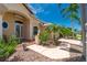 Charming home exterior featuring an arched entrance, manicured landscaping, and paver walkway at 1453 Wren Ct, Punta Gorda, FL 33950