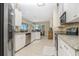 Open kitchen featuring stainless appliances, stone backsplash, and a view into the breakfast nook at 1453 Wren Ct, Punta Gorda, FL 33950