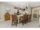 Kitchen island features bar-style seating and granite countertops, with neutral tile flooring throughout at 1453 Wren Ct, Punta Gorda, FL 33950