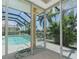 The screened-in lanai features a pool and lush tropical landscaping at 1453 Wren Ct, Punta Gorda, FL 33950