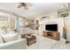 Spacious living room featuring neutral paint, tile floors, ceiling fan, and staircase with decorative metal railing at 1453 Wren Ct, Punta Gorda, FL 33950